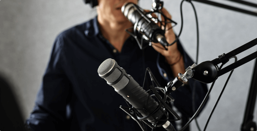 man speaking in to a podcast microphone